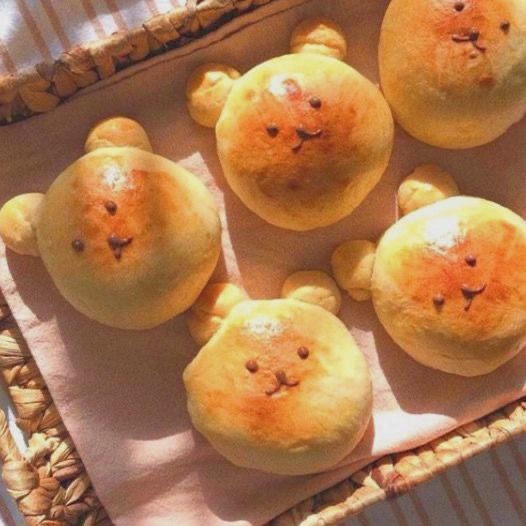 some bread shaped like teddy bears sitting in a basket