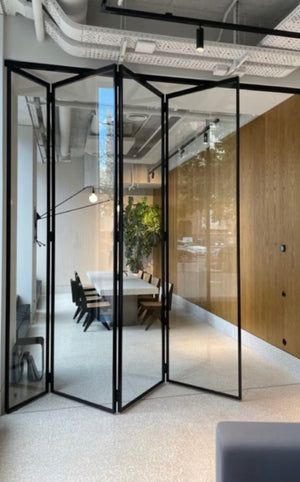 an office with glass walls and wooden paneling