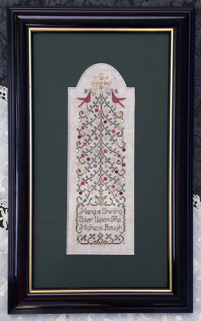 a cross stitched christmas tree in a black frame