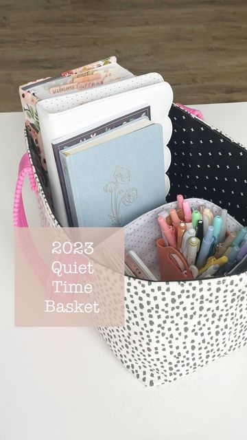 a polka dot basket with pens, pencils and other items in it on a table