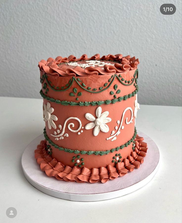 a three tiered cake decorated with flowers and leaves