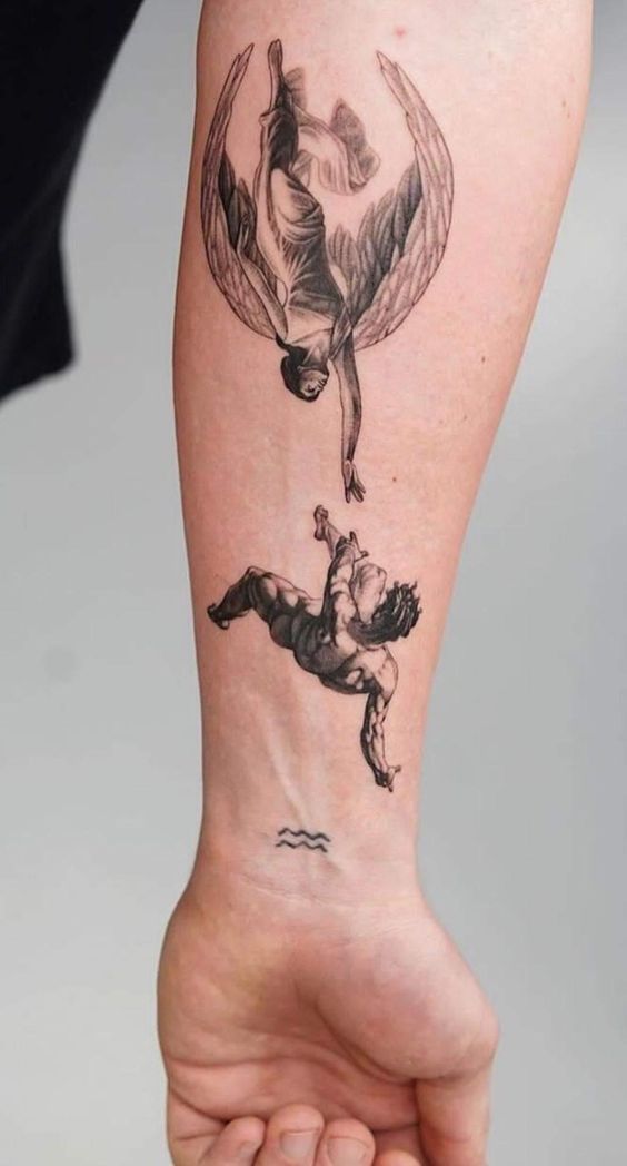 a person with a tattoo on their arm that has an image of two people flying