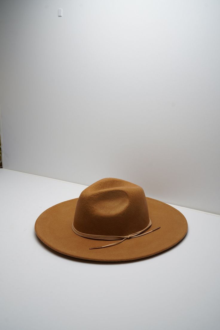 Be ready for whatever adventures life throws at you with the Lulus Take the Scenic Route Fedora Hat! Soft felt shapes this essential fedora with a semi-structured wide-brim and a traditional tear-drop crown. Matching leather string band adds just the perfect amount of something' extra! Internal drawstrings allow for the perfect fit. 100% Australian wool Spot Clean Please Read Before Purchasing: Our hats are made to fit average head sizes, the average adult head circumference to be 55cm (21 3⁄4 ) Luxury Brown Fedora With Flat Crown, Luxury Brimmed Fedora, One Size Fits Most, Luxury Brimmed Fedora One Size, Luxury Wide Brim Felt Fedora, Luxury Fitted Brown Fedora, Luxury Wide Brim Fitted Hats, Luxury Handwoven Wide-brim Fedora, Luxury Adjustable Panama Hat With Brim, Luxury Natural Color Flat Brim Hat