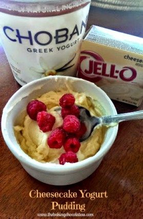 a bowl of yogurt with raspberries in it next to an ice cream container