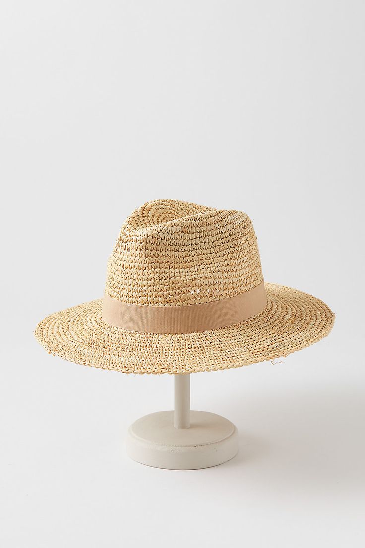 For a fresh summer look, head out with the Charlie safari hat as your finishing touch. Whether you're wearing a sundress or a linen shirt, you'll be ready for sun, sand, and socializing in this dapper design. Crafted from crocheted raffia, this lightweight hat features a grosgrain hatband with bow and an adjustable sweatband for all-day comfort. Summer Travel Sun Hat Made Of Toquilla Straw, Summer Coastal Hats For Travel, Lightweight Coastal Sun Hat For Summer, Coastal Style Lightweight Sun Hat For Summer, Beige Bohemian Panama Hat For Warm Weather, Summer Fedora Hat For Warm Weather, Bohemian Beige Panama Hat For Warm Weather, Summer Cream Fedora In Toquilla Straw, Adjustable Straw Hat For Summer Travel