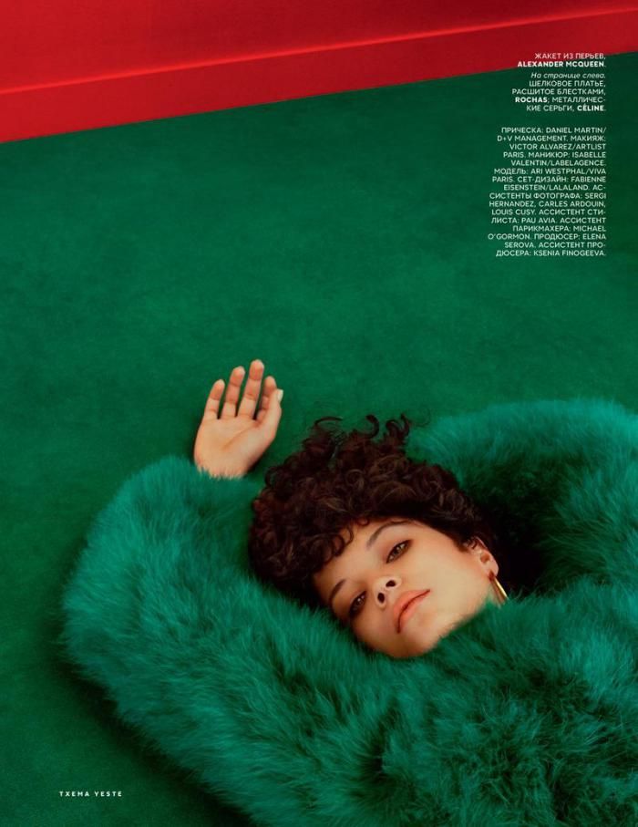 a woman laying on top of a green blanket