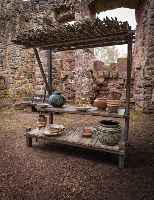 an old stone building with pots and bowls on it's shelf in the middle