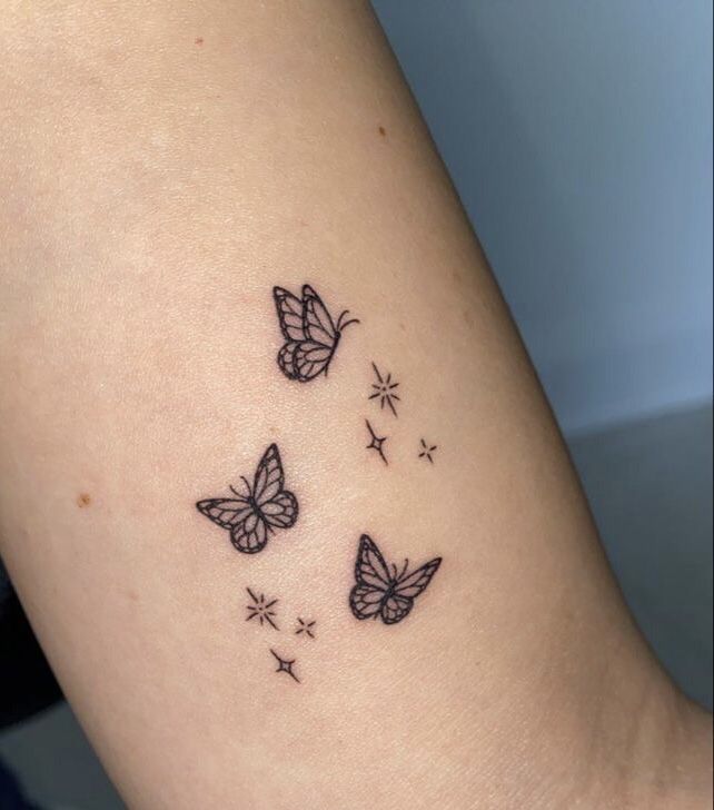 three small butterflies on the arm