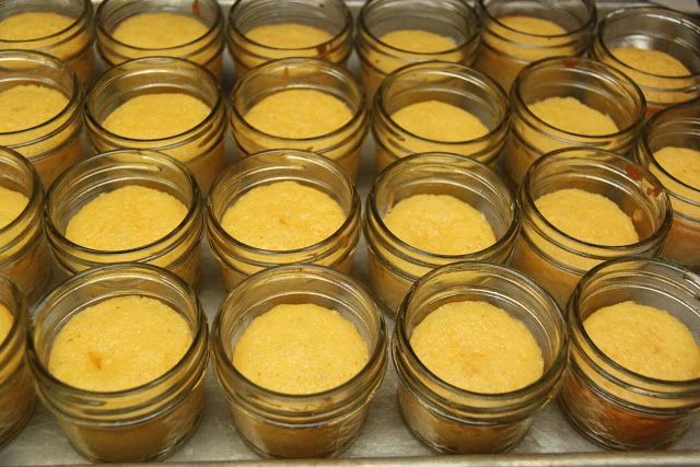 rows of jars filled with food sitting on top of a metal tray next to each other