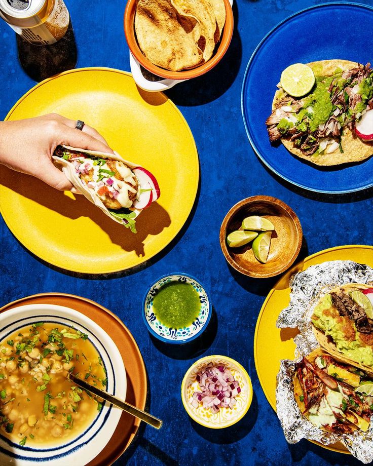 several plates of food on a blue table