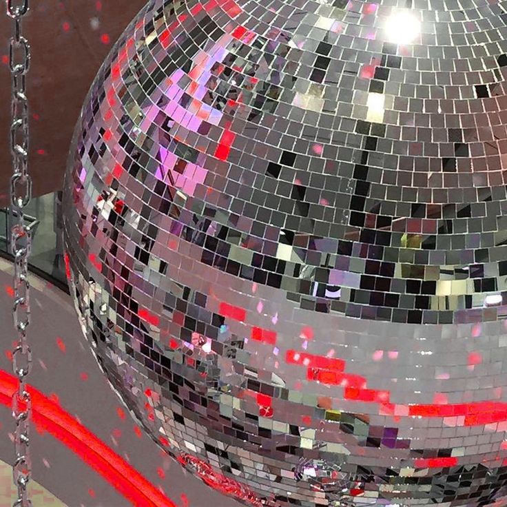 a disco ball with red and white confetti on it