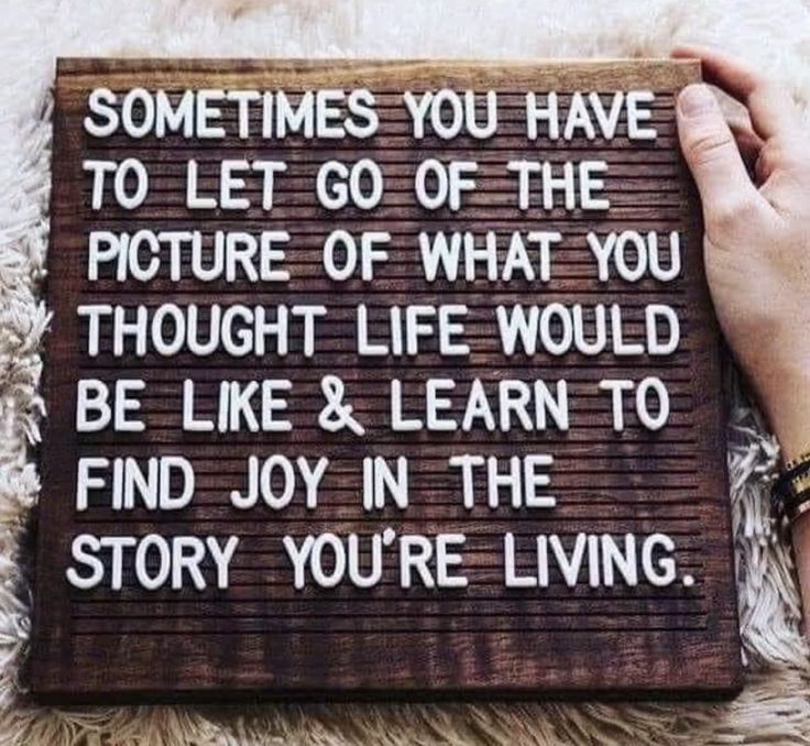 someone holding up a sign that says sometimes you have to let go of the picture of what you thought life would be like & learn to find joy in the story you're