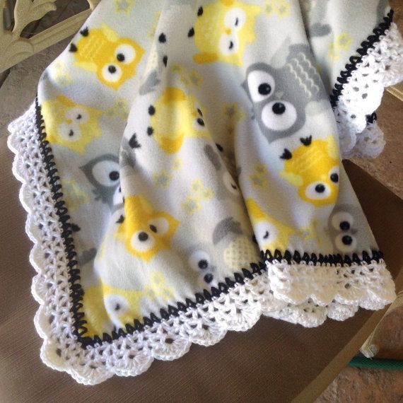 a yellow and gray blanket with owls on it