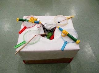 a white box with some colorful objects on it's lid sitting on a table