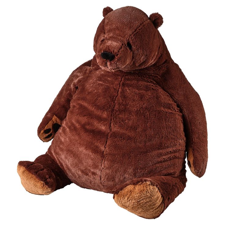 a large brown teddy bear sitting up against a white background