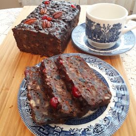 two pieces of chocolate cake on a blue and white plate next to a coffee cup