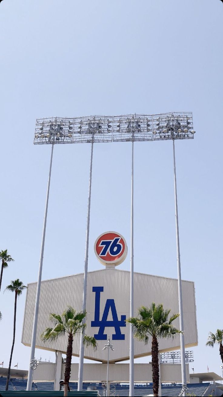 a baseball stadium with palm trees and a sign for the dodgers on it's side