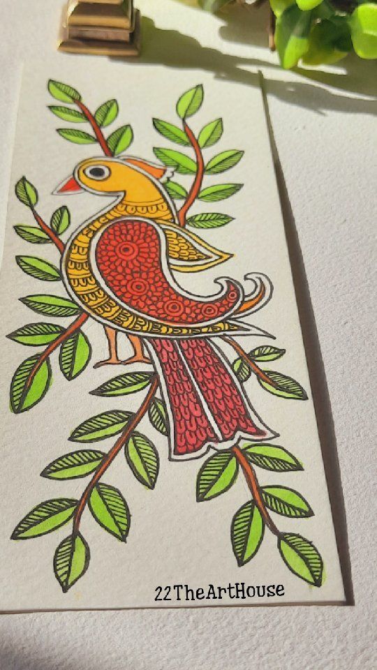 a card with a bird on it sitting next to some flowers and green leafy branches