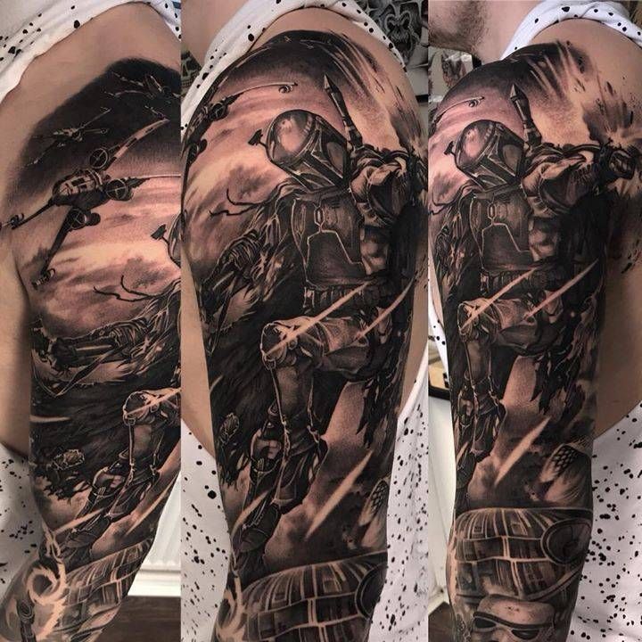 a man's arm with a black and grey tattoo on it, depicting two soldiers