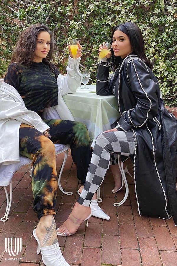 two women sitting at a table with drinks