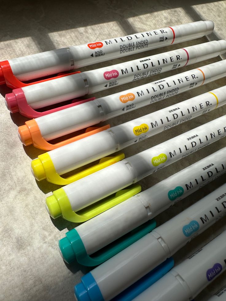 several different colored markers lined up in a row