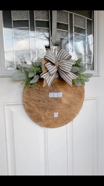 a wooden door with a bow hanging on it