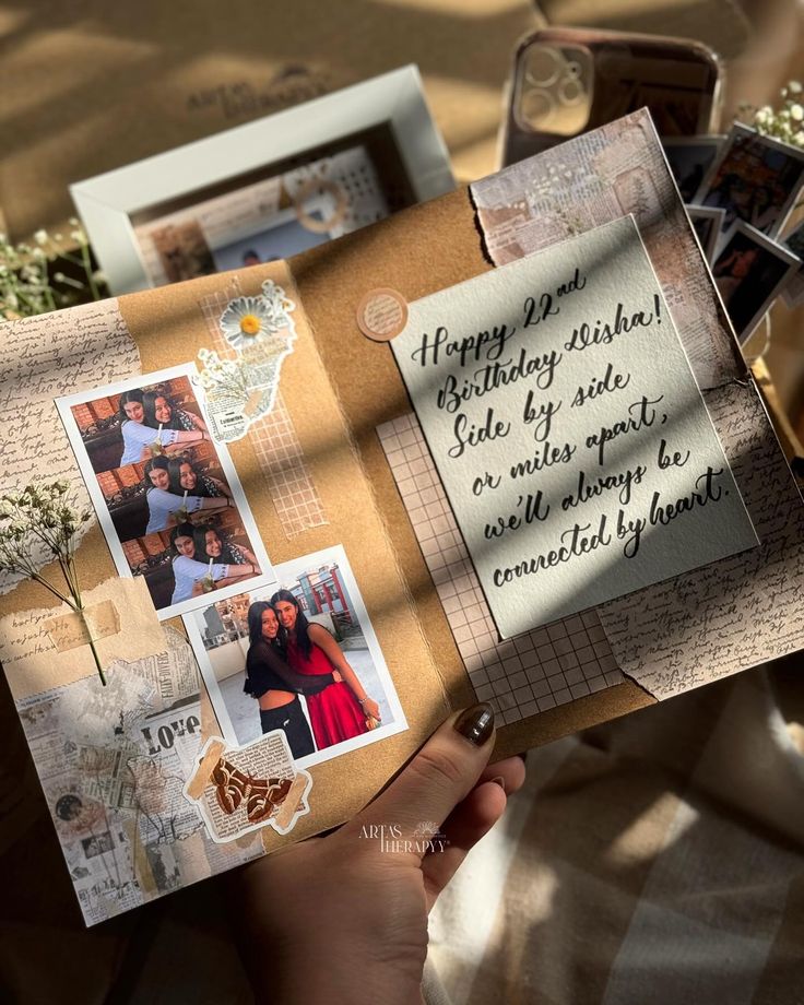 a person holding an open book with pictures and words on the pages that say happy birthday