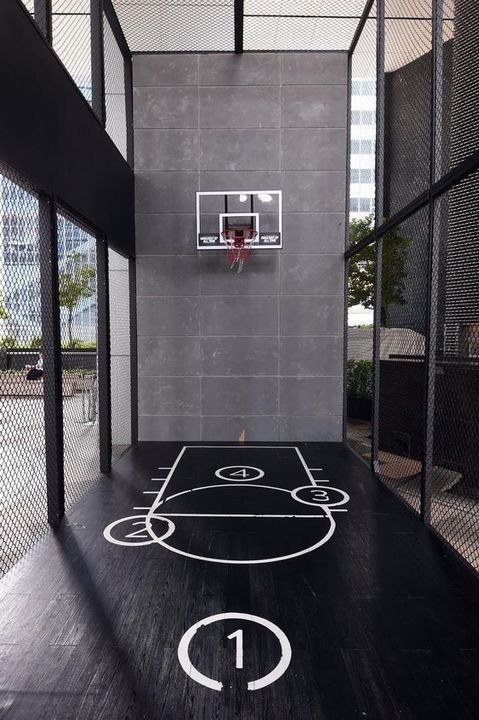 an indoor basketball court with the number one painted on it's floor and hoop