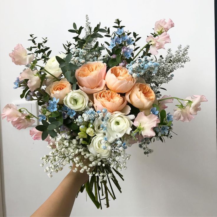 a vase filled with lots of pink and white flowers