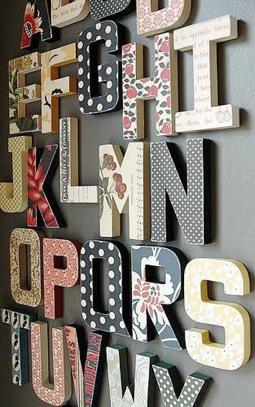 the letters are made out of wood and have polka dot designs on them, as well as flowers