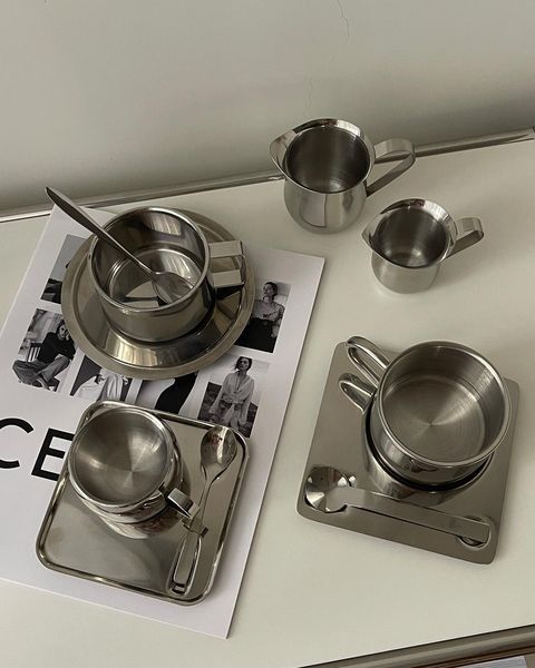 an assortment of stainless steel kitchen ware on a white counter top with the words ice cream written below it