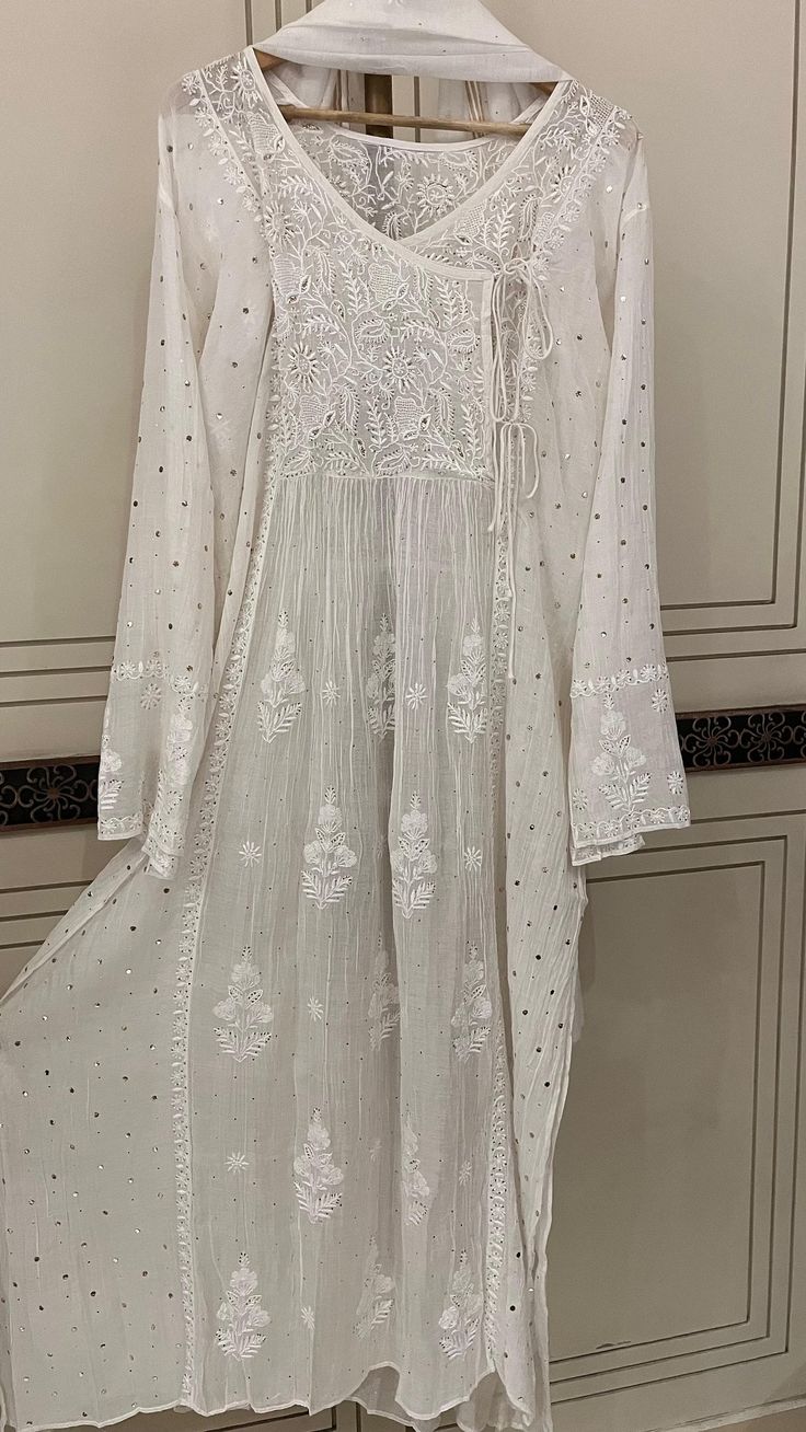 Discover the epitome of timeless elegance with our Pure Cotton Silk Angarkha Set, adorned with vintage Chikankari Ek Taar embroidery. This exquisite piece is further embellished with intricate Mukaish and Pitta work, creating a luxurious blend of tradition and modernity. The kurta comes with a matching dupatta and lining, and you have the option to choose between churidhaar or pants for the bottoms, allowing you to tailor the set to your personal style. Each set is customizable to any size, ensuring a perfect fit for everyone. Please send your size specifications before placing your order. Embrace the allure of heritage craftsmanship with this stunning ensemble, perfect for any special occasion. Pitta Work, Salwar Kameez, Cotton Silk, Pure Cotton, Timeless Elegance, Personal Style, Special Occasion, Perfect Fit, Etsy Uk