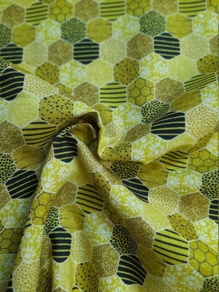 a yellow and black fabric with hexagons on it