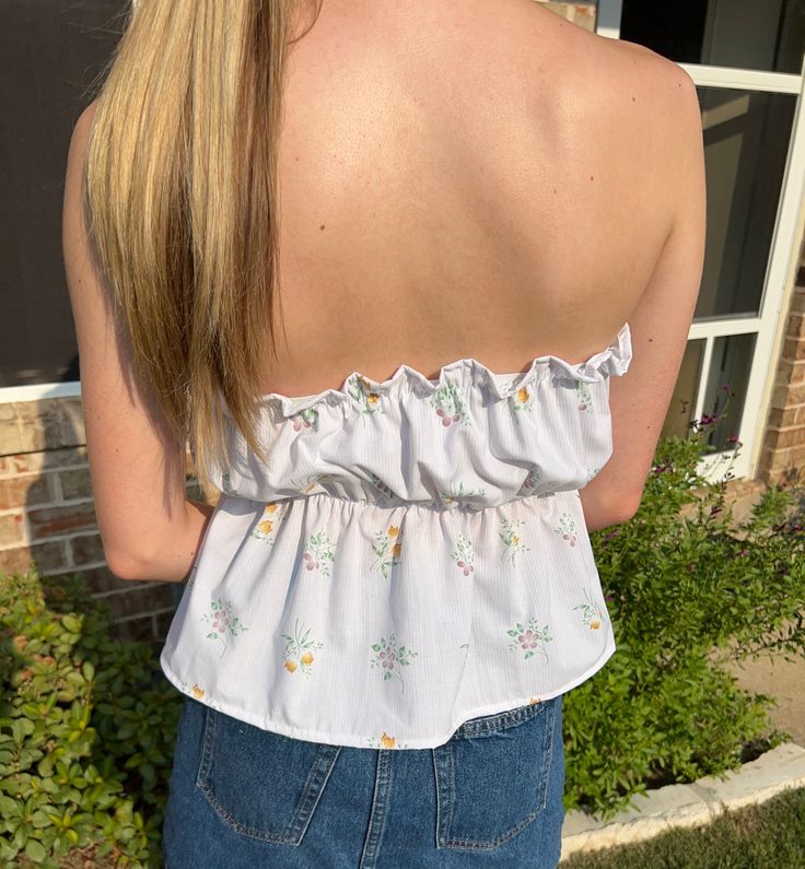 Get ready to turn heads in The Amelia Top! Made with love from 100% thrifted materials, this scrunch tube top features a playful mix of dainty pinstripes and floral bouquets. With an elasticized design, it's easily adjustable for a perfect fit. Size Guide: Size 4: Bust 33-36, Waist 27-30 Size 10: Bust 36-40, Waist 30-34 Feminine Spring Strapless Tops, Feminine Strapless Top For Spring, Spring Bandeau Tube Top With Floral Print, Feminine Fitted Tube Top For Spring, Spring Stretch Tube Top With Smocked Bodice, Floral Print Bandeau Tube Top For Day Out, Strapless Floral Print Top For Spring, Spring Tube Top With Smocked Back, Spring Bandeau Top With Smocked Back