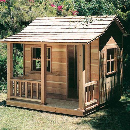 a small wooden house in the middle of some grass