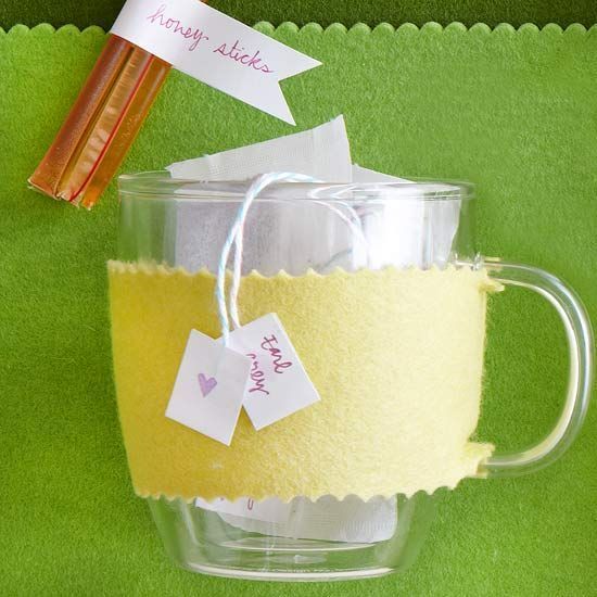 a glass mug filled with yellow liquid and two tags attached to it