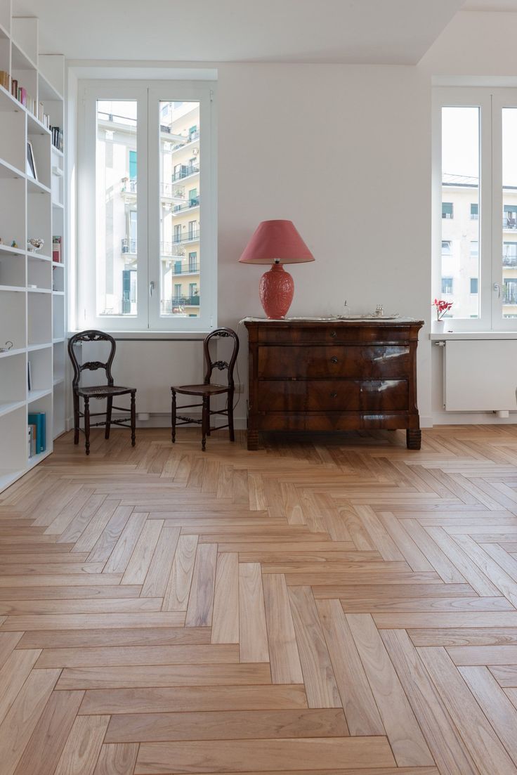 a living room with wooden floors and white walls