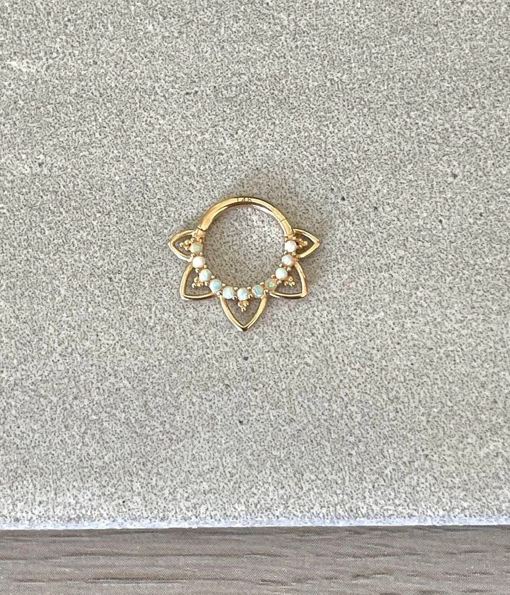 "This solid gold 8mm or 10mm septum piercing ring is made of 14K gold, and has faux opals. Please note that the 10mm size has one extra set of \"spikes\" because of the larger size. Piercing \"clicks\" into place. Super dainty minimalist look - drop jaws with this body jewelry! **Please upgrade to priority shipping at checkout for an additional $3 if you would like to insure your package! I am not responsible for lost, delayed or stolen packages.** Details & Size: ♥ 14k Gold - Yellow or White Go Gold Septum Ring Tarnish Resistant As A Gift, Gold Tarnish-resistant Septum Ring As Gift, Gold Tarnish Resistant Septum Ring Gift, Elegant 14k Gold Hypoallergenic Septum Ring, Hypoallergenic 14k Gold Septum Ring, Dainty 14k Gold Septum Ring, Dainty 14k Gold Round Septum Ring, 14k Gold Dainty Round Septum Ring, Gold Stackable Septum Ring For Everyday