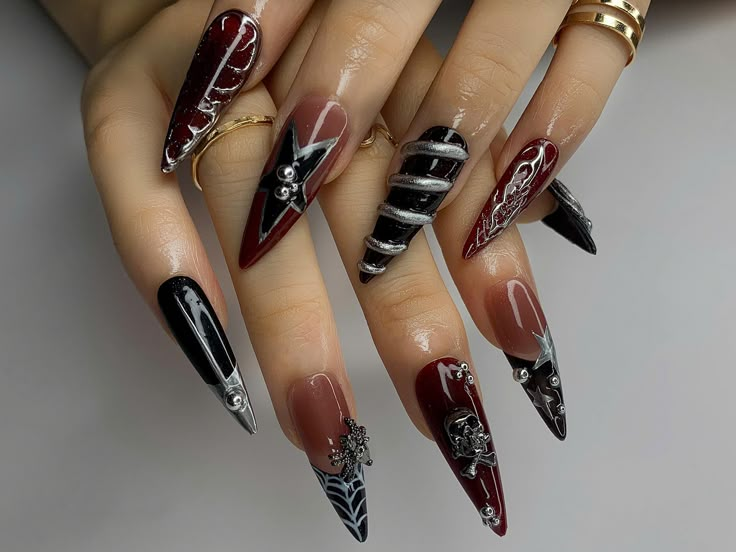 🖤 Gothic Elegance Press On Nails - Embrace Your Dark Side! 💀 Step into the world of gothic luxury with these stunning press-on nails that blend edgy design with dark sophistication. Perfect for those who love to make a bold statement, this set features deep reds, blacks, and metallic accents, creating a look that's both mysterious and captivating. Whether you're preparing for a special occasion or just want to add some drama to your everyday style, these nails are sure to turn heads! ⚡ Design Highlights: 3D Skull & Crossbones: The hand-painted skull and crossbones add a rebellious edge to your nails, making a fierce statement that's perfect for gothic fashion lovers. These details are meticulously crafted to ensure a realistic and bold appearance. Metallic Accents: The silver metallic ac Gothic Halloween Nails, Red Black And Silver Nails, Gothic Nail Designs, Dark Red And Black Nails, Dark Goth Nails, Red Black And White Nails, Red And Black Nails, Ongles Goth, 3d Skull