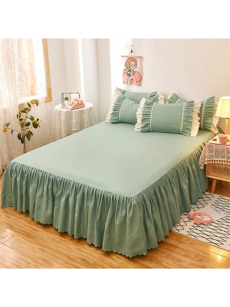 a bed with green ruffled bedspread and pillows