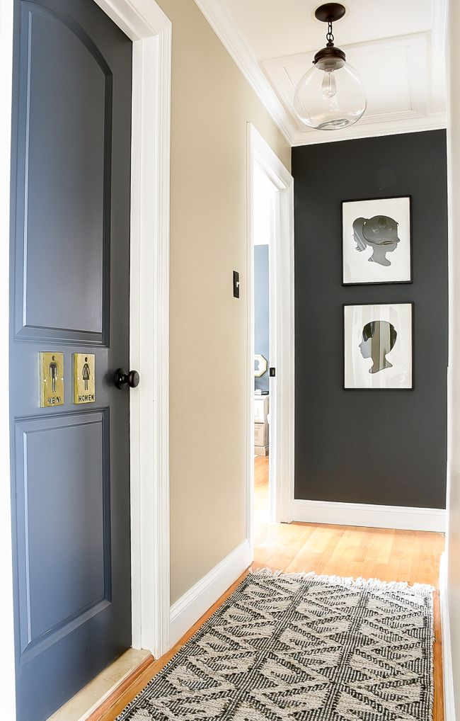 an entryway with two blue doors and a rug on the floor in front of it