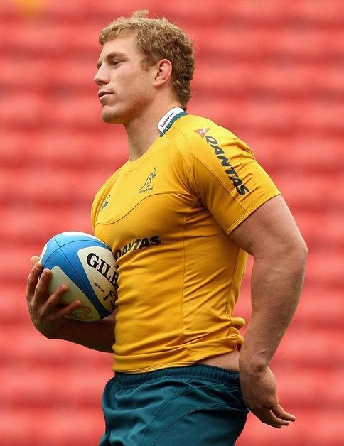 a rugby player holding a ball in his hands