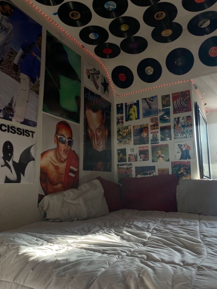 a bed with lots of records on the wall