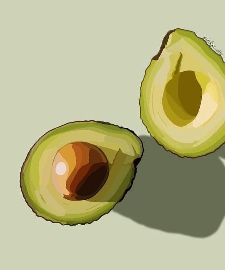 an avocado cut in half on a gray background