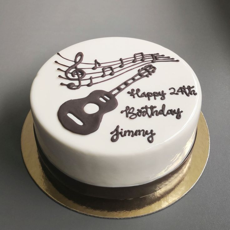 a birthday cake decorated with musical notes and a guitar