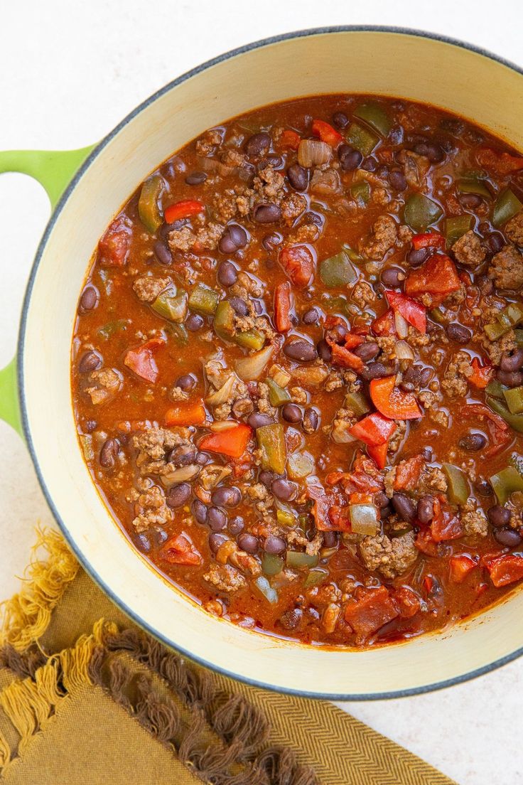 a pot filled with chili and beans on top of a table