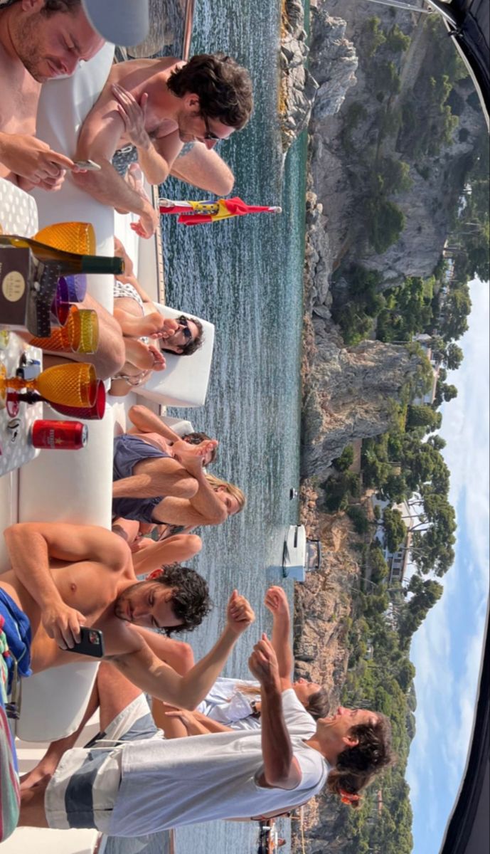 a group of people standing on top of a boat