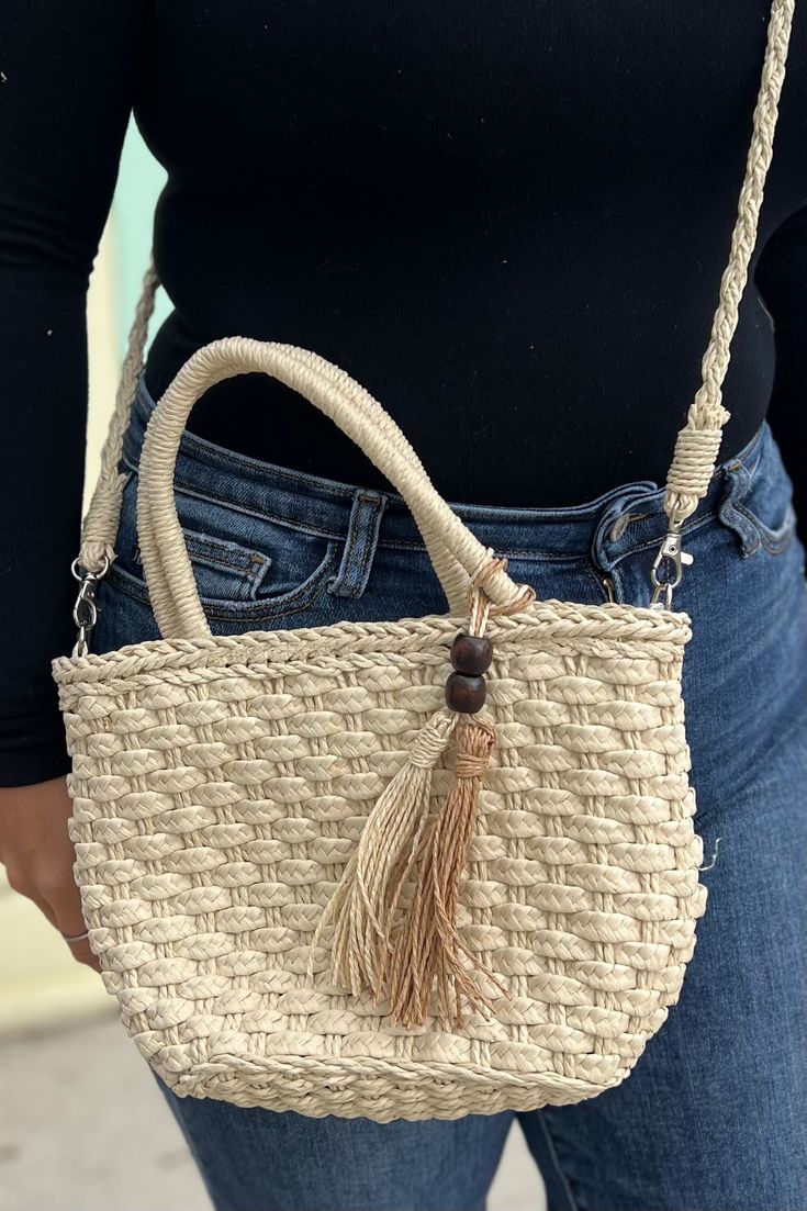 Small, woven, and oh-so-cute - this straw beach bag with a shoulder strap and accent tassels is just what you need for your beachy, boho day! Dimensions: 7.5” x 11” Beige Vacation Bags With Adjustable Handle, Beige Vacation Bag With Adjustable Handle, Vacation Shoulder Satchel Bag With Adjustable Handle, Beige Satchel Straw Bag With Adjustable Handle, Beach Shoulder Bag With Double Adjustable Handle, Beige Straw Shoulder Bag With Adjustable Handle, Beige Straw Bag With Adjustable Handle For Daily Use, Vacation Tote Shoulder Bag With Adjustable Handle, Beige Straw Tote Bag With Adjustable Handle