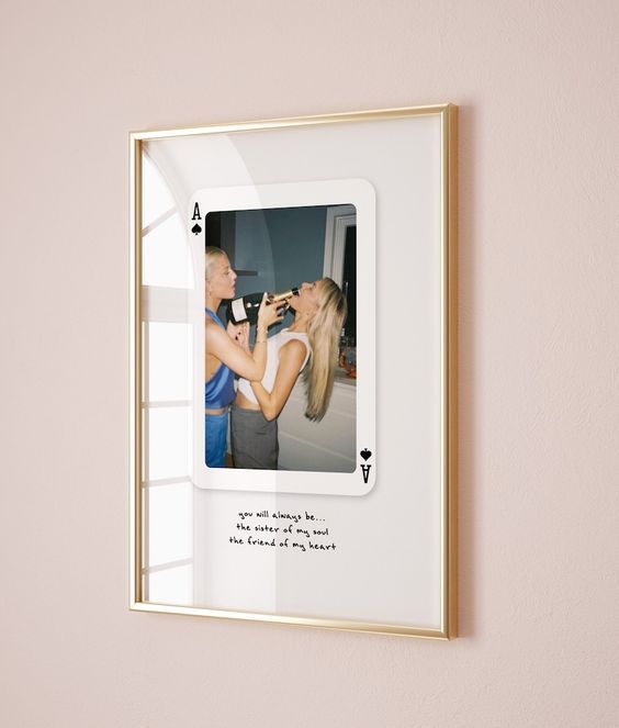 a photo frame hanging on the wall with a woman kissing a man's face