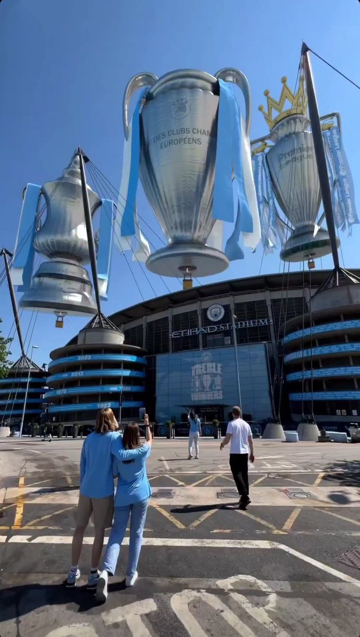 two people are standing in front of the stadium